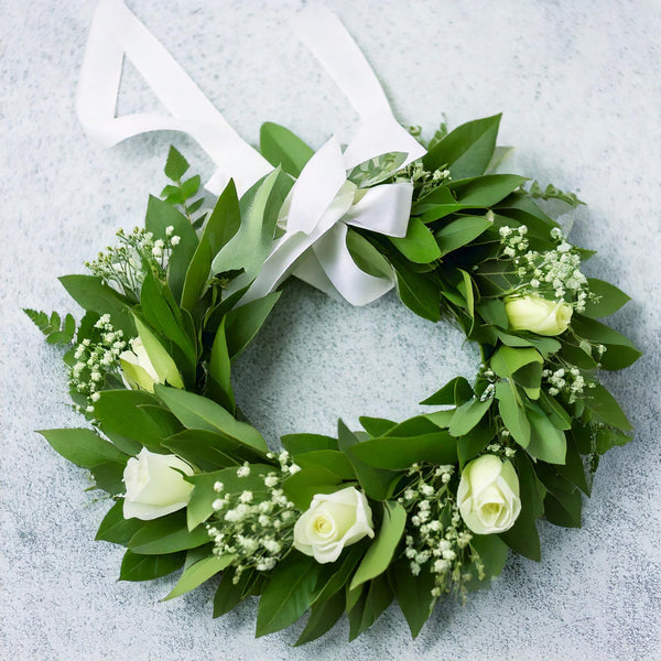 Corona con rose bianche, gypsophila e nastro di raso | Consegna Fiori a Domicilio per Laurea
